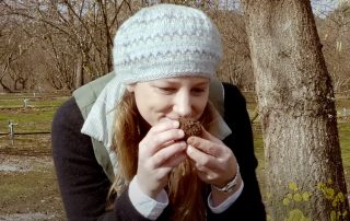 A photo of Pascale from Free Range Living, inhaling the aroma of a truffle she's just unearthed in the Truffiere at Millgrove Truffles